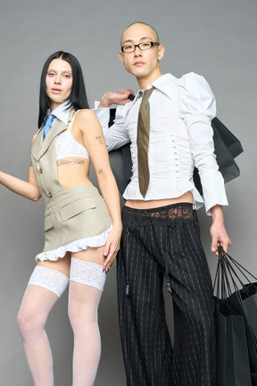 white puff shoulder blouse with corset lace up sides and button front worn by model studio ecommerce image