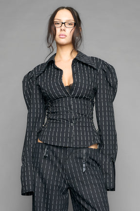 black print puff shoulder blouse with corset lace up sides and button front worn by model studio ecommerce image