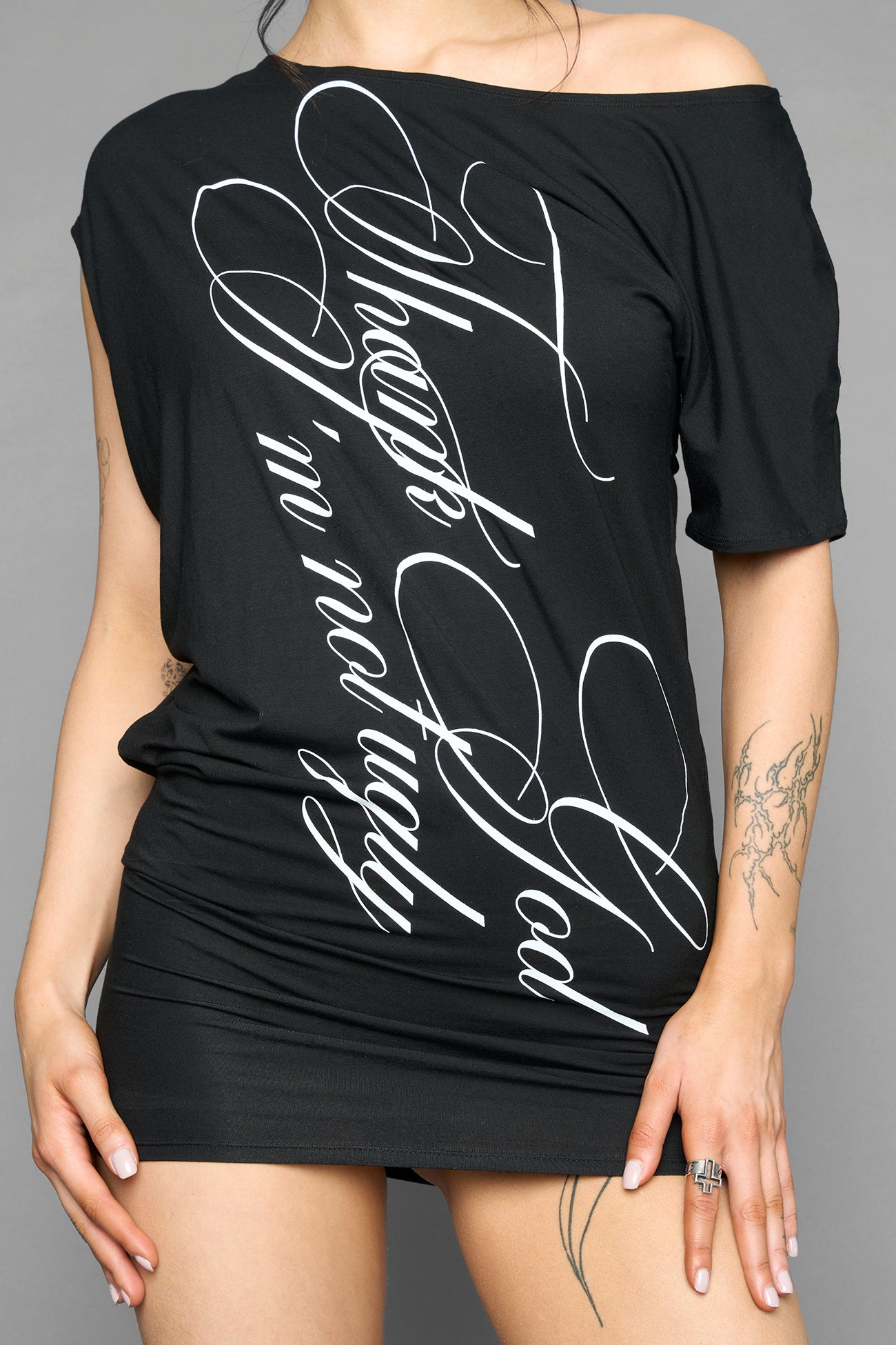 black off shoulder mini dress with oversized script text print and short sleeves worn by model studio ecommerce image
