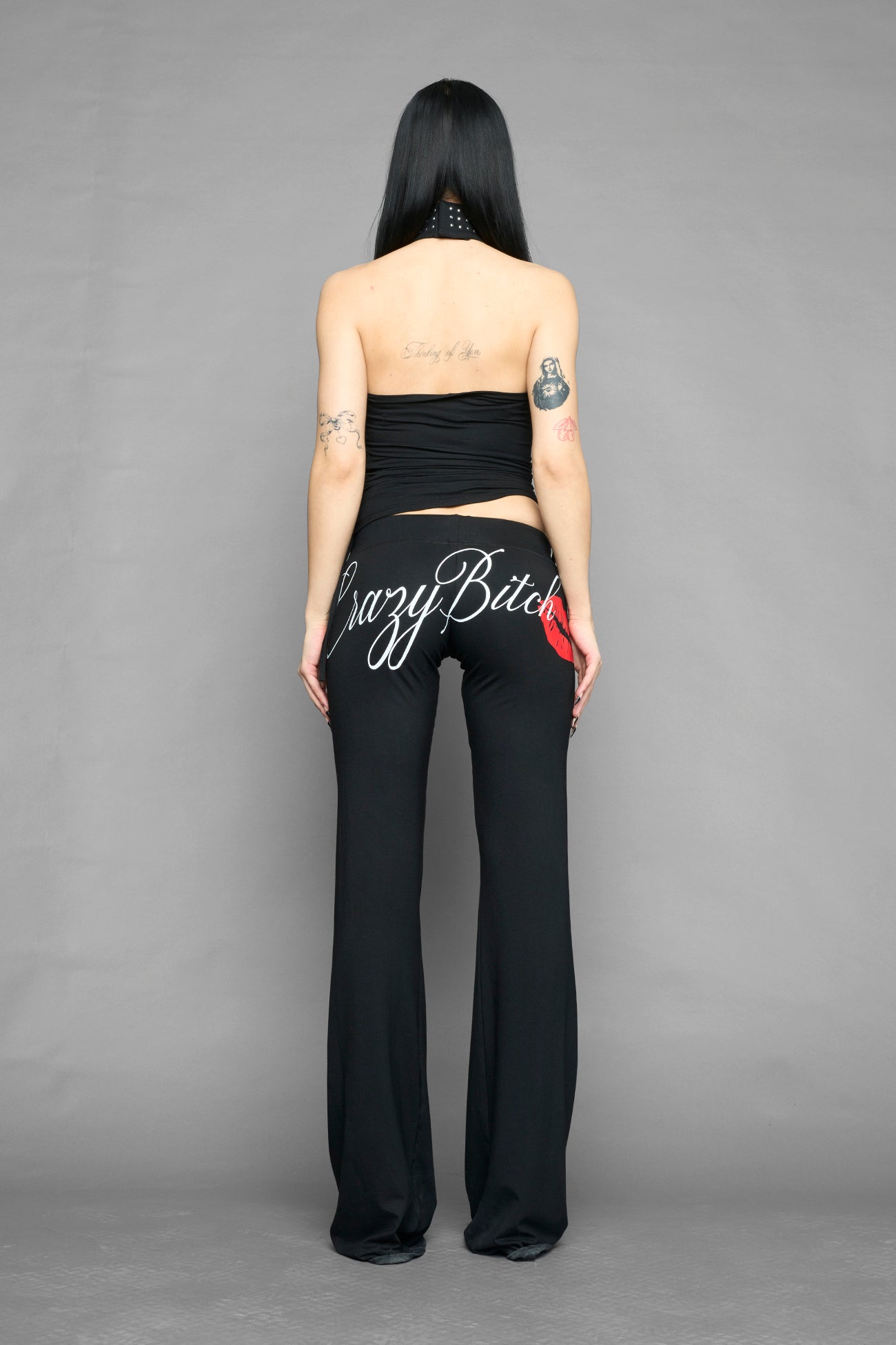 model wearing black printed top neckholder with studded collar