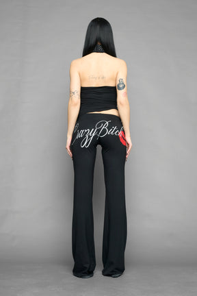 model wearing black printed top neckholder with studded collar