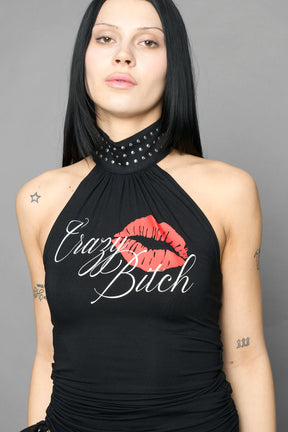 model wearing black printed top neckholder with studded collar