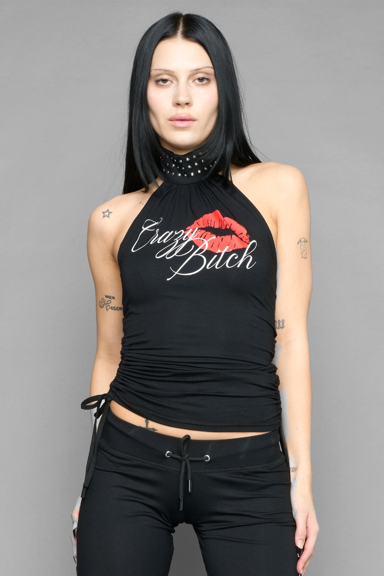 model wearing black printed top neckholder with studded collar