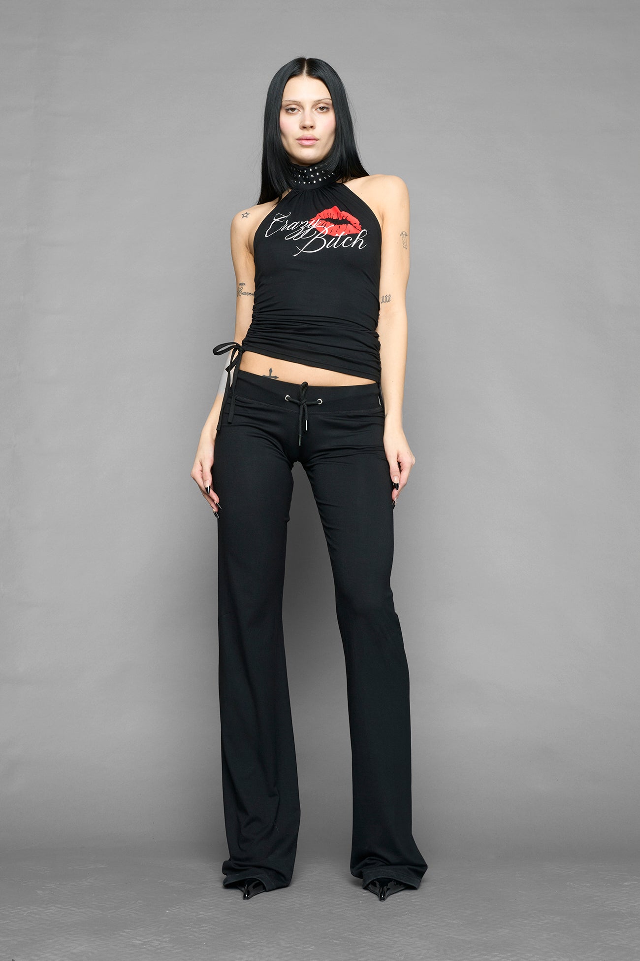 model wearing black printed top neckholder with studded collar