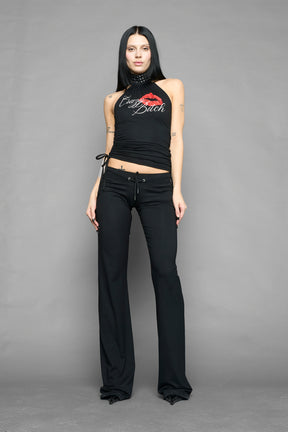 model wearing black printed top neckholder with studded collar