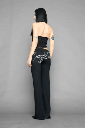 model wearing black printed top neckholder with studded collar