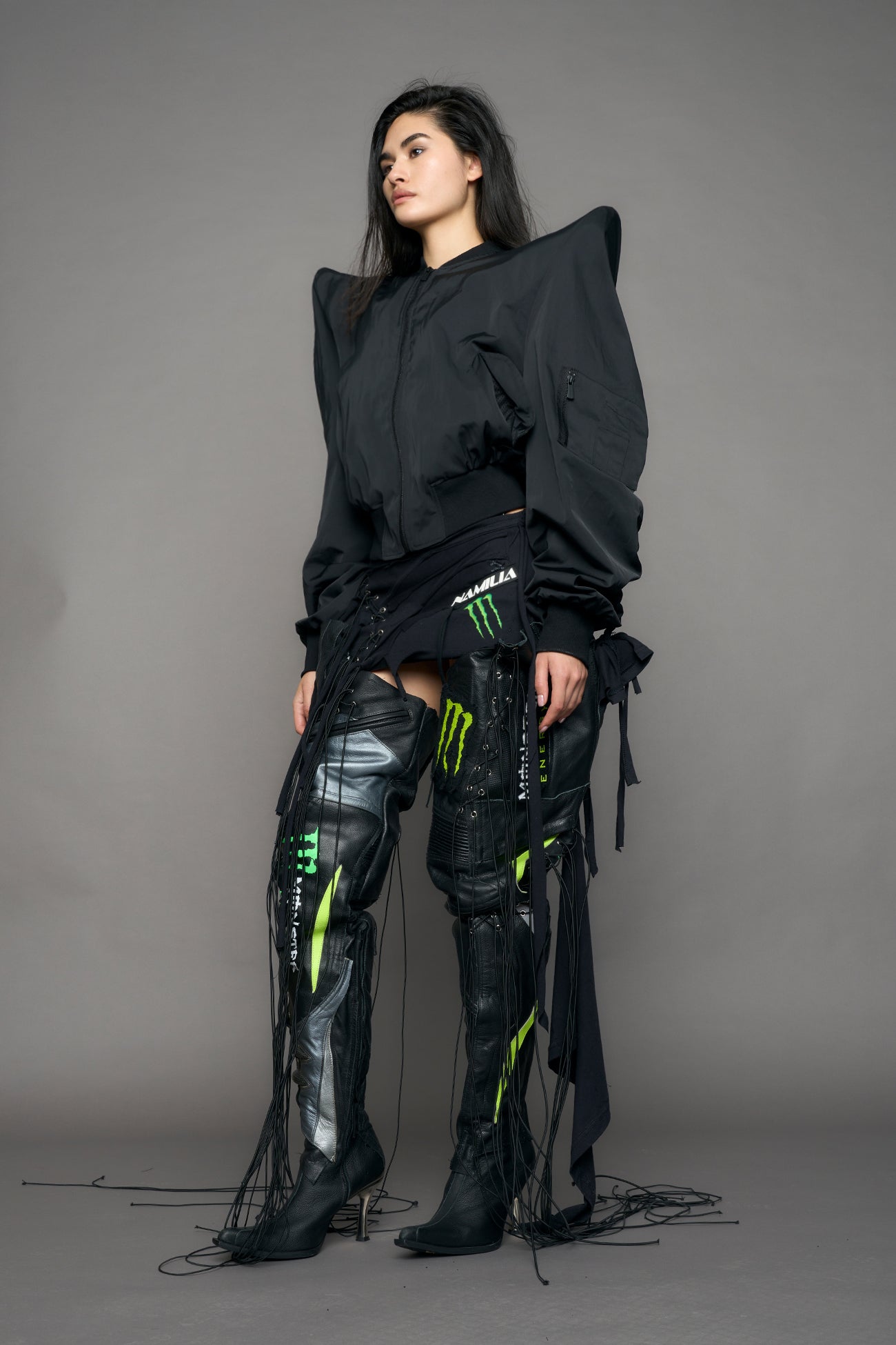 model wearing black bomber jacket with sharp shoulder design