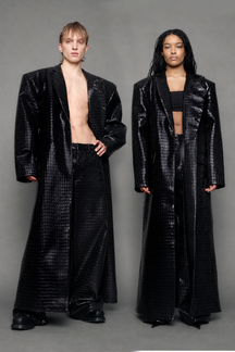 Two models wearing long black croc textured coat against a gray background