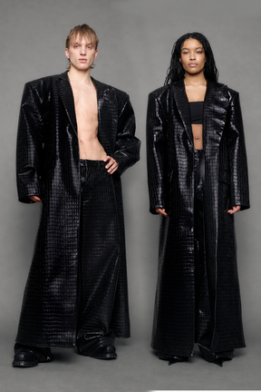 Two models wearing long black croc textured coat against a gray background