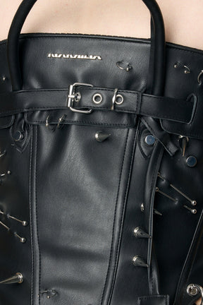 model wearing black studded handbag corset 