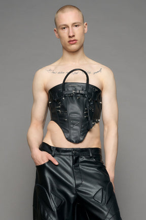 model wearing black studded handbag corset 