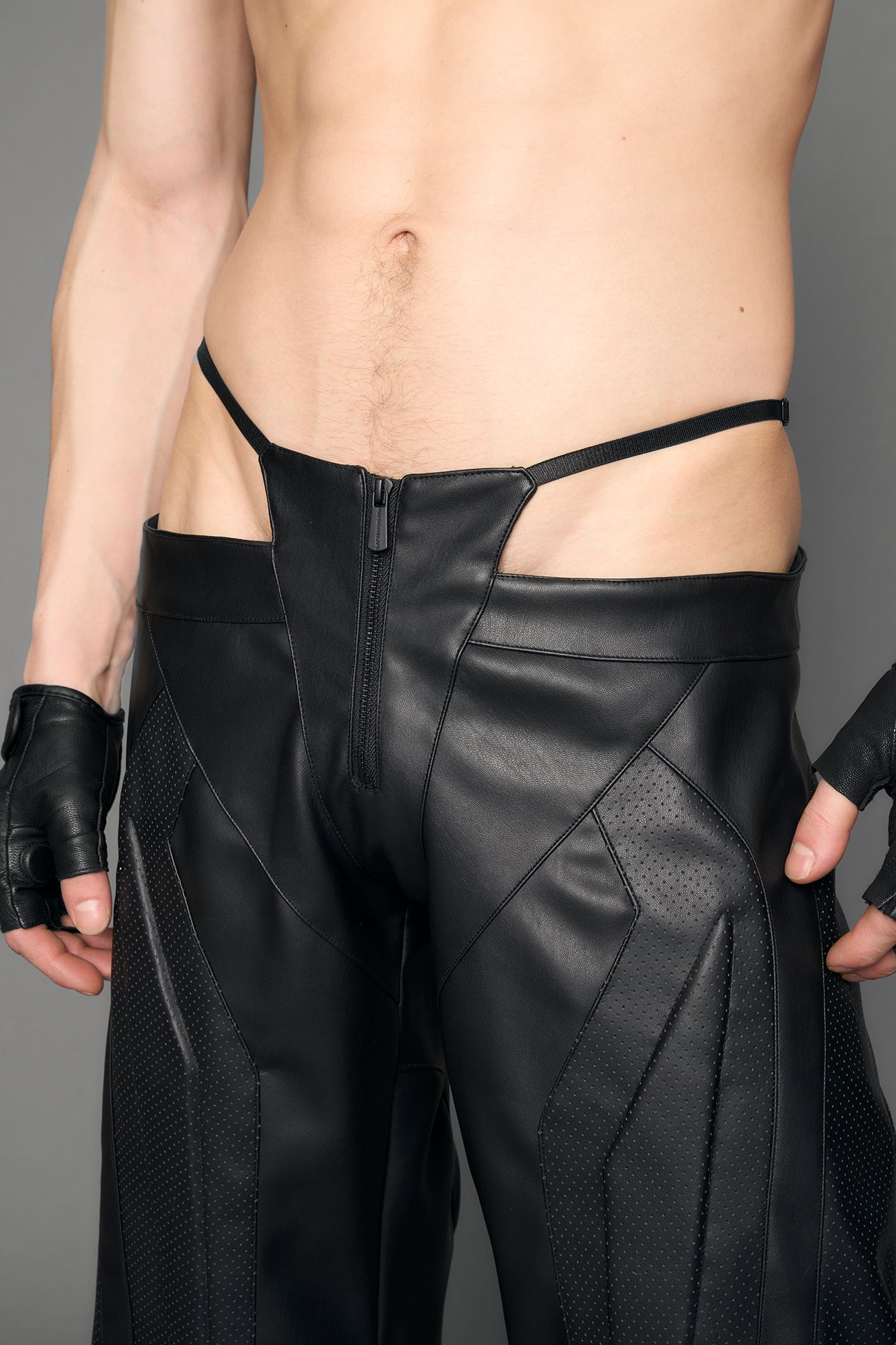 model wearing black vegan leather thong pants