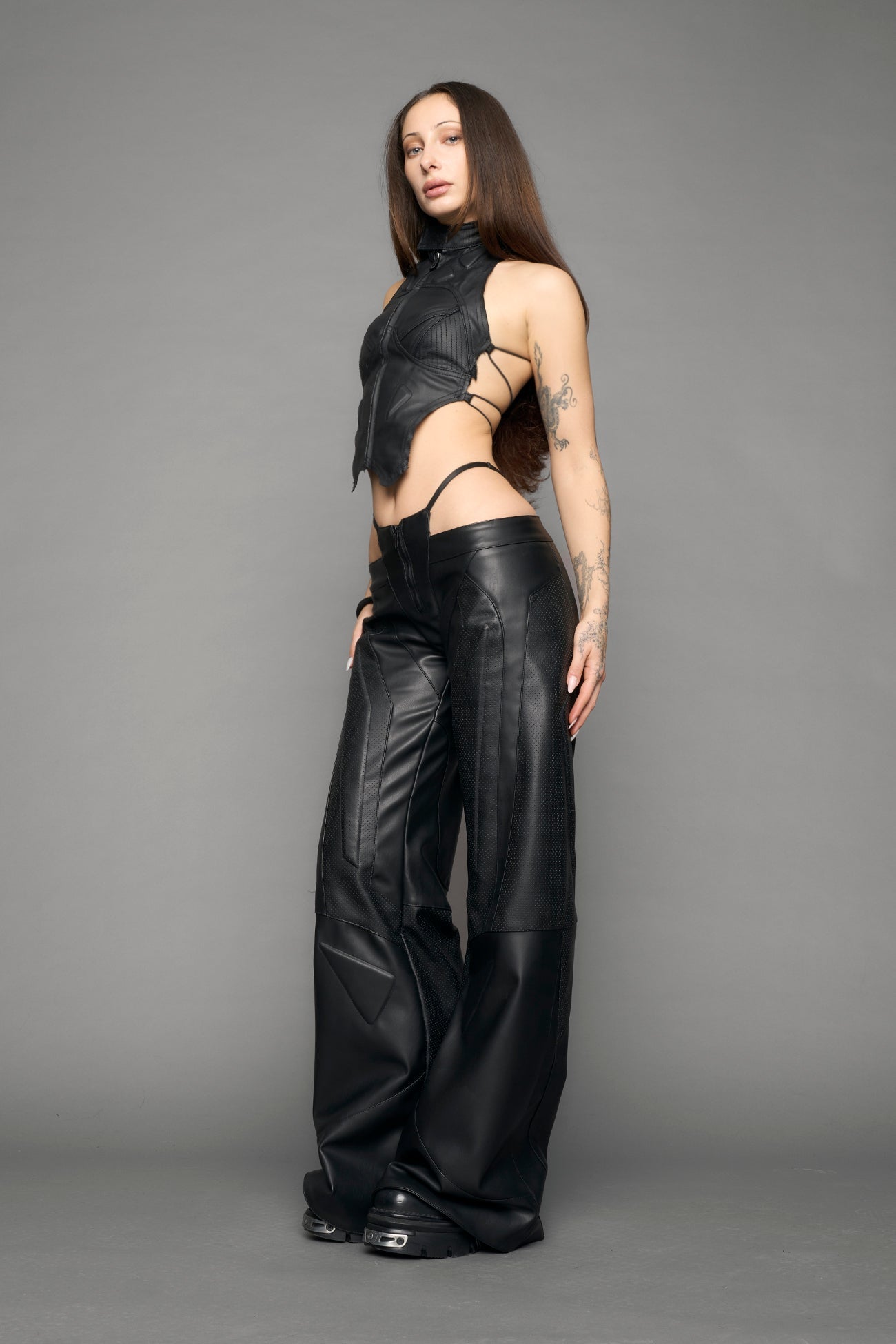 model wearing black vegan leather thong pants