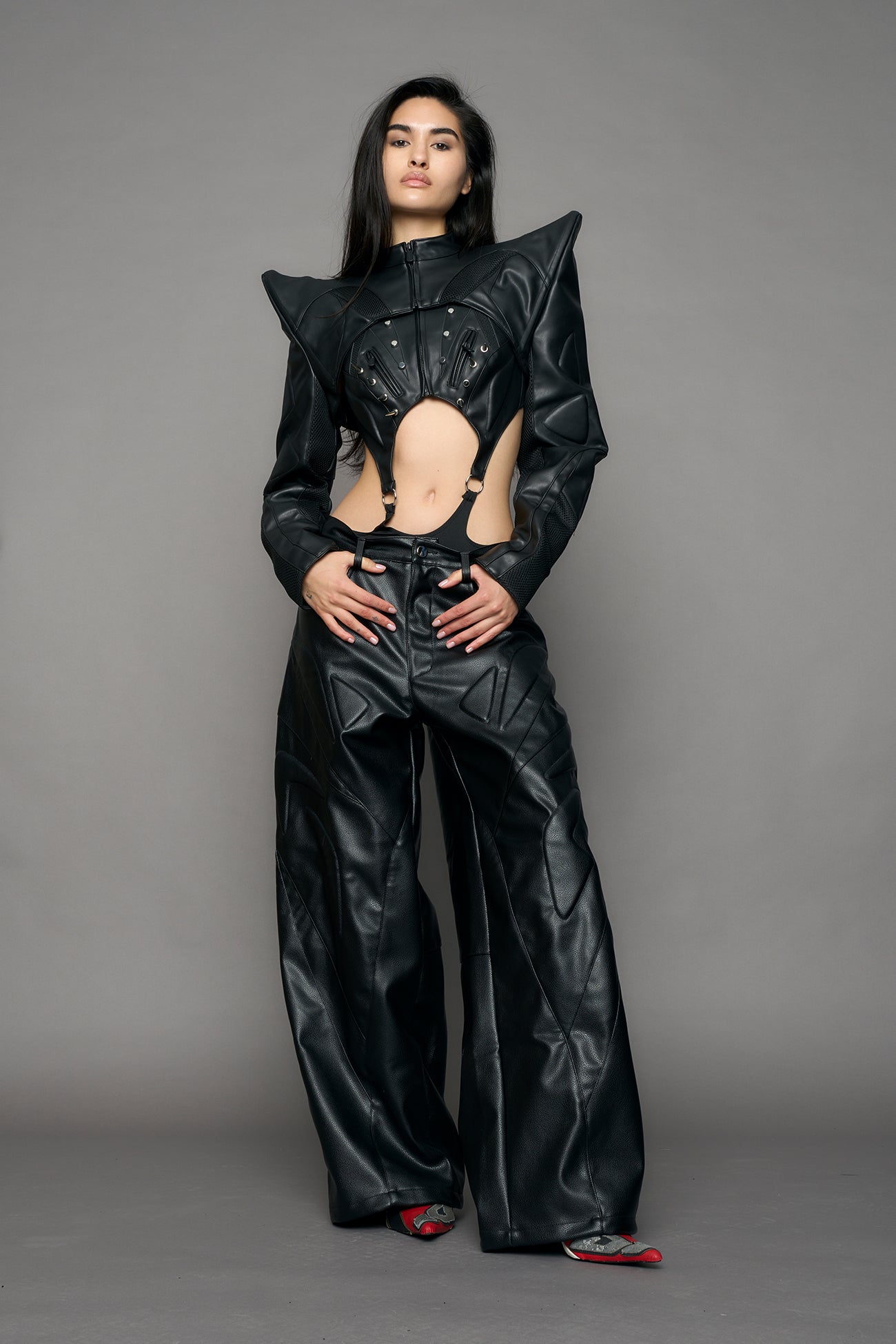 Model wearing a black leather choker jacket with cut-out design 