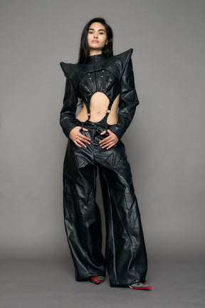 Model wearing a black leather choker jacket with cut-out design 