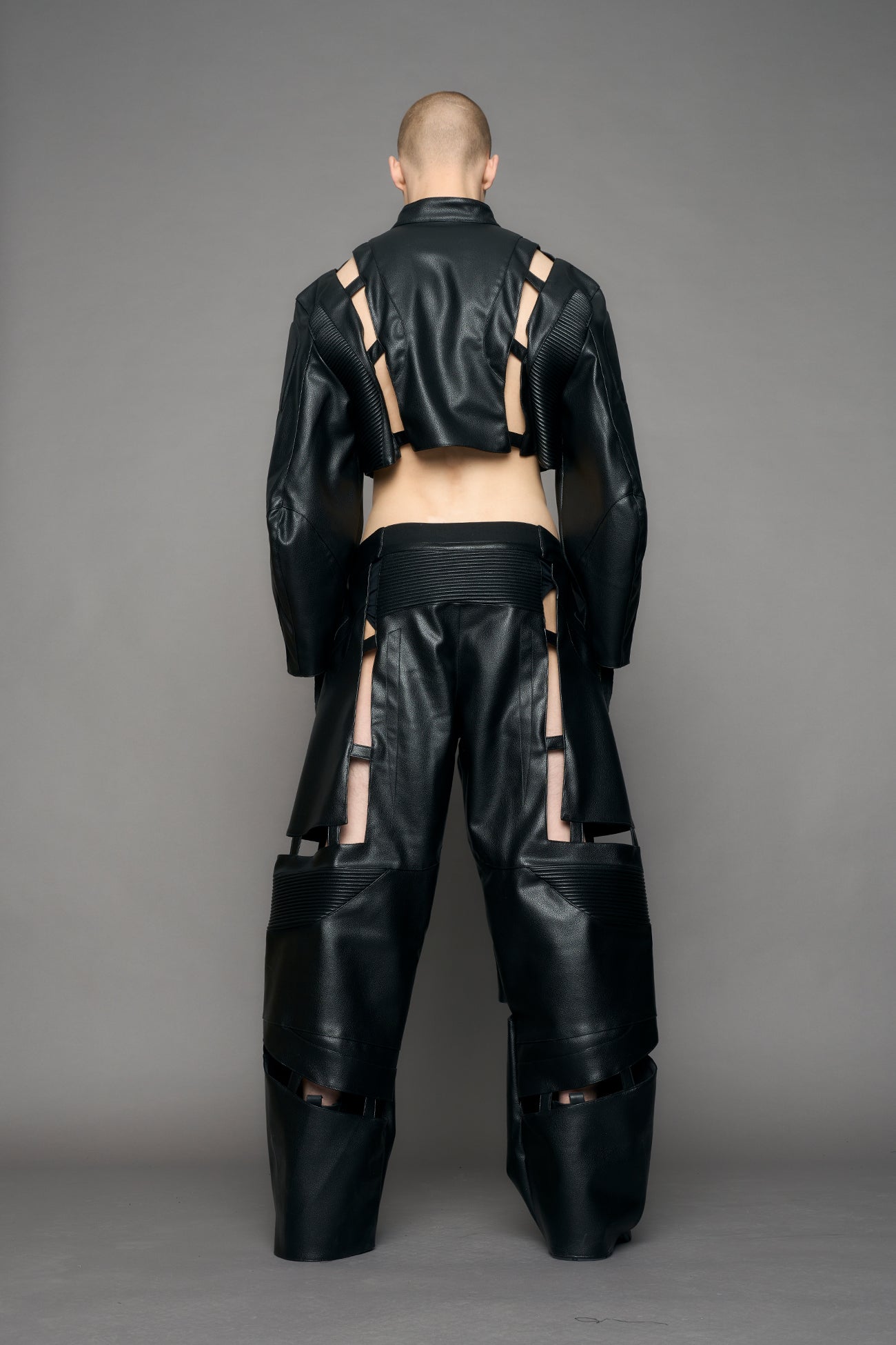 model wearing black moto pu leather jacket with cut out design
