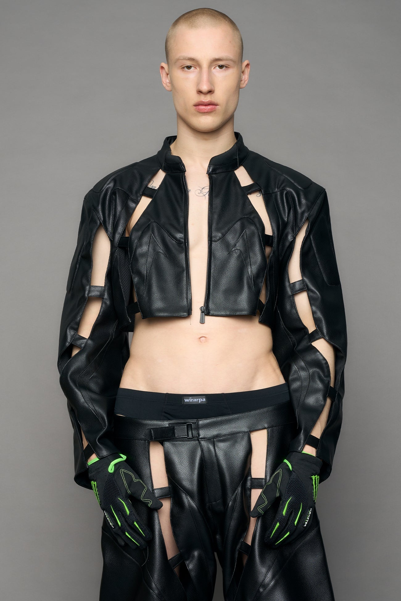 model wearing black moto pu leather jacket with cut out design