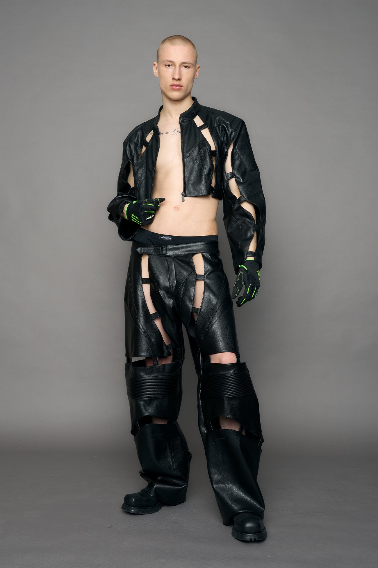model wearing black moto pu leather jacket with cut out design