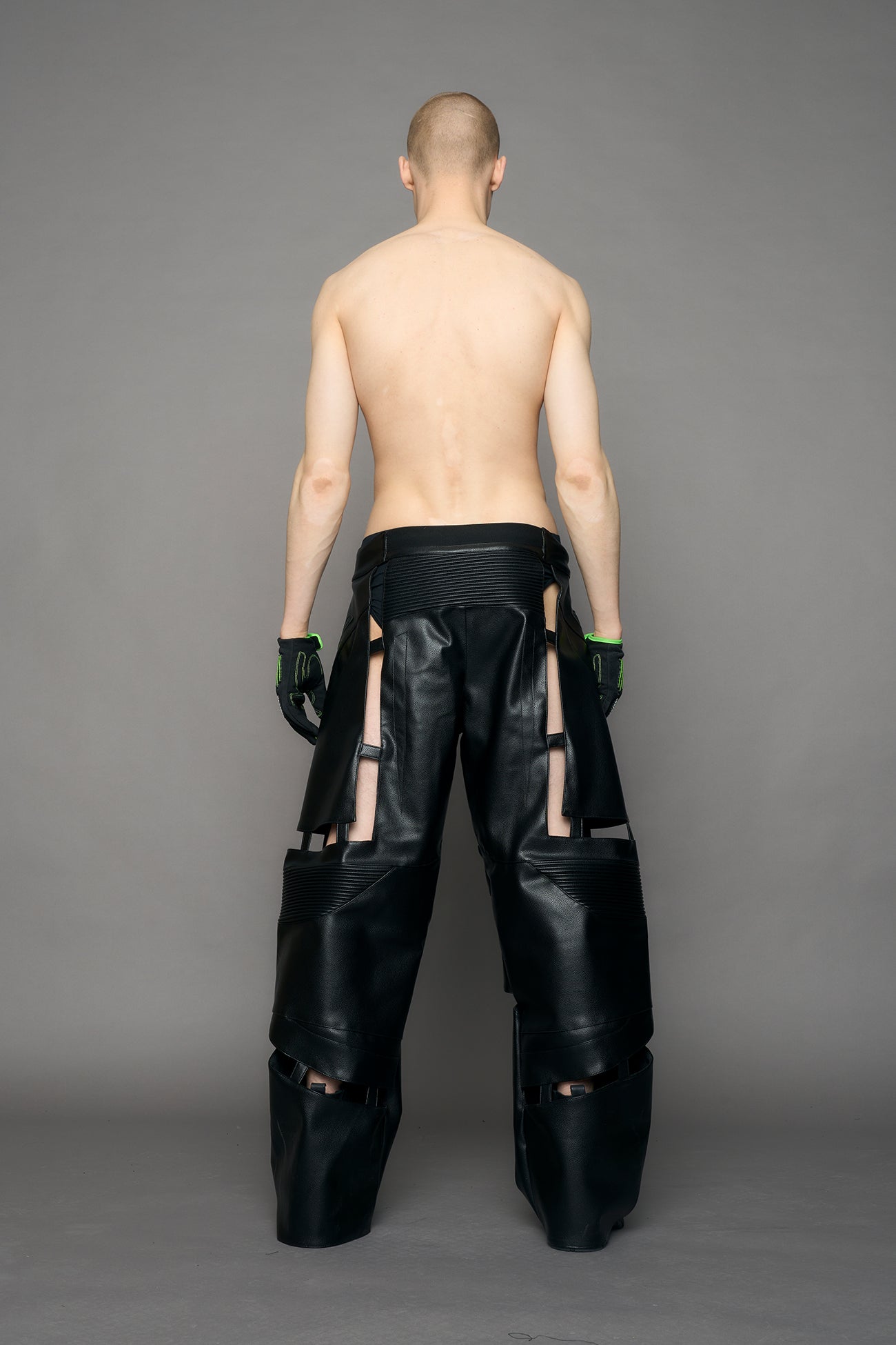 model wearing black pu leather pants with cut out details
