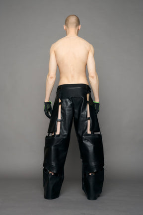 model wearing black pu leather pants with cut out details