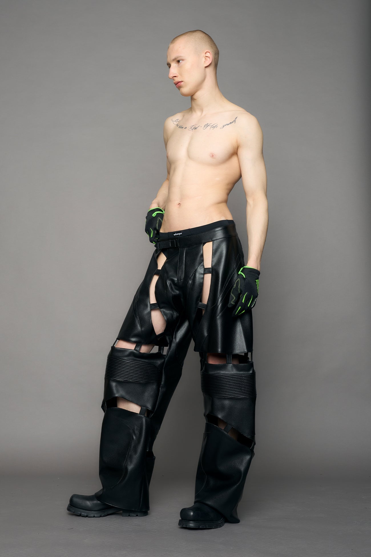 model wearing black pu leather pants with cut out details