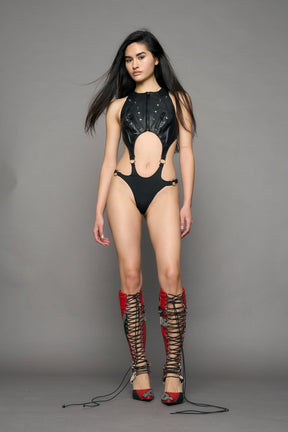 model wearing black studded moto body with cut out design