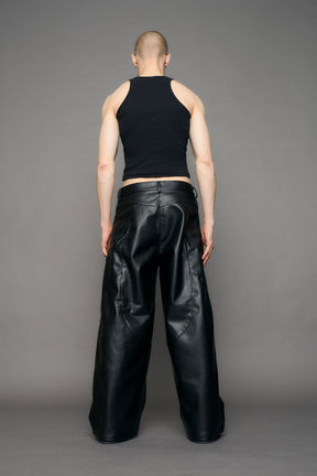 model wearing black oversize pu leather pants with moto style highlights