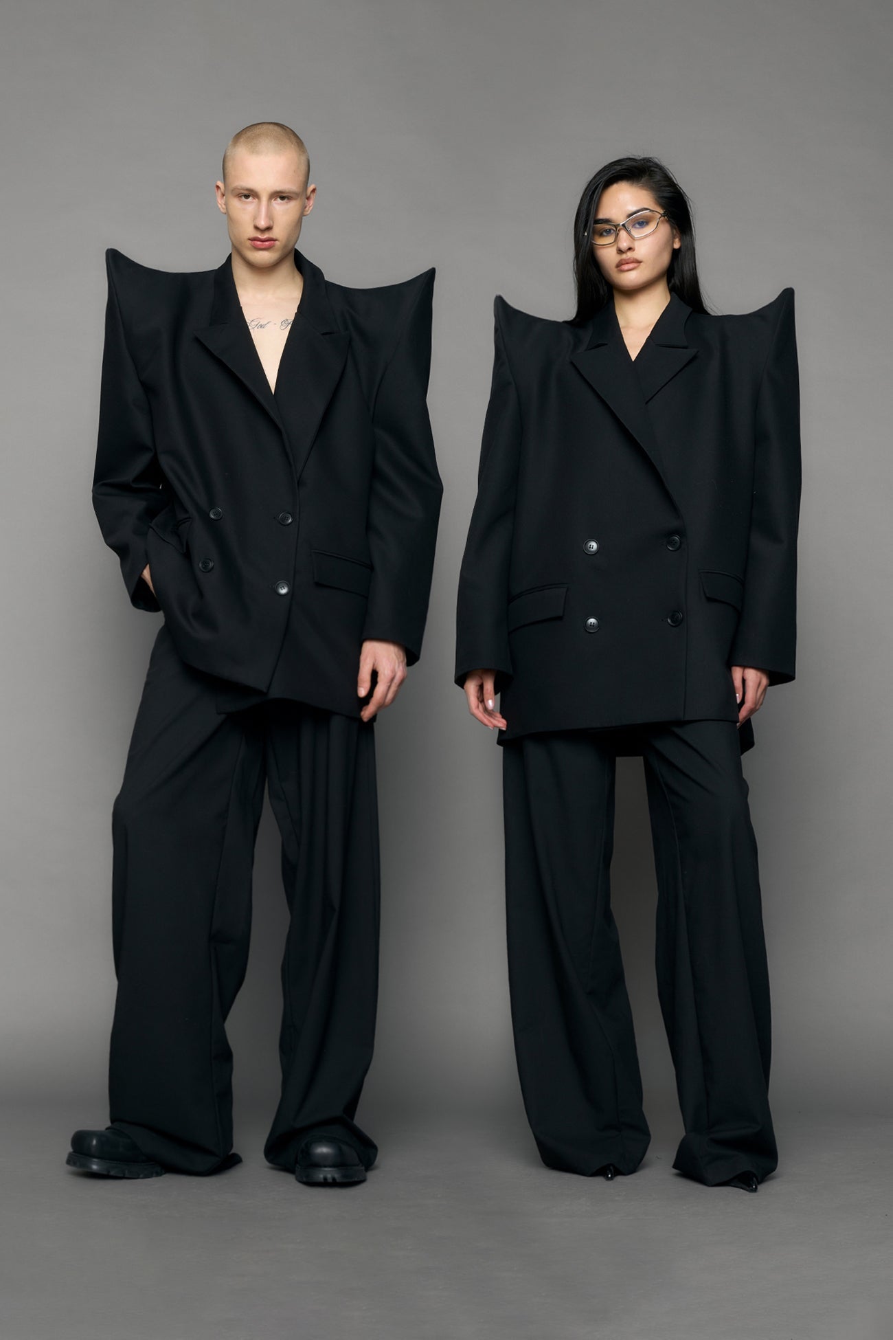 model wearing black blazer with sharp shoulder design