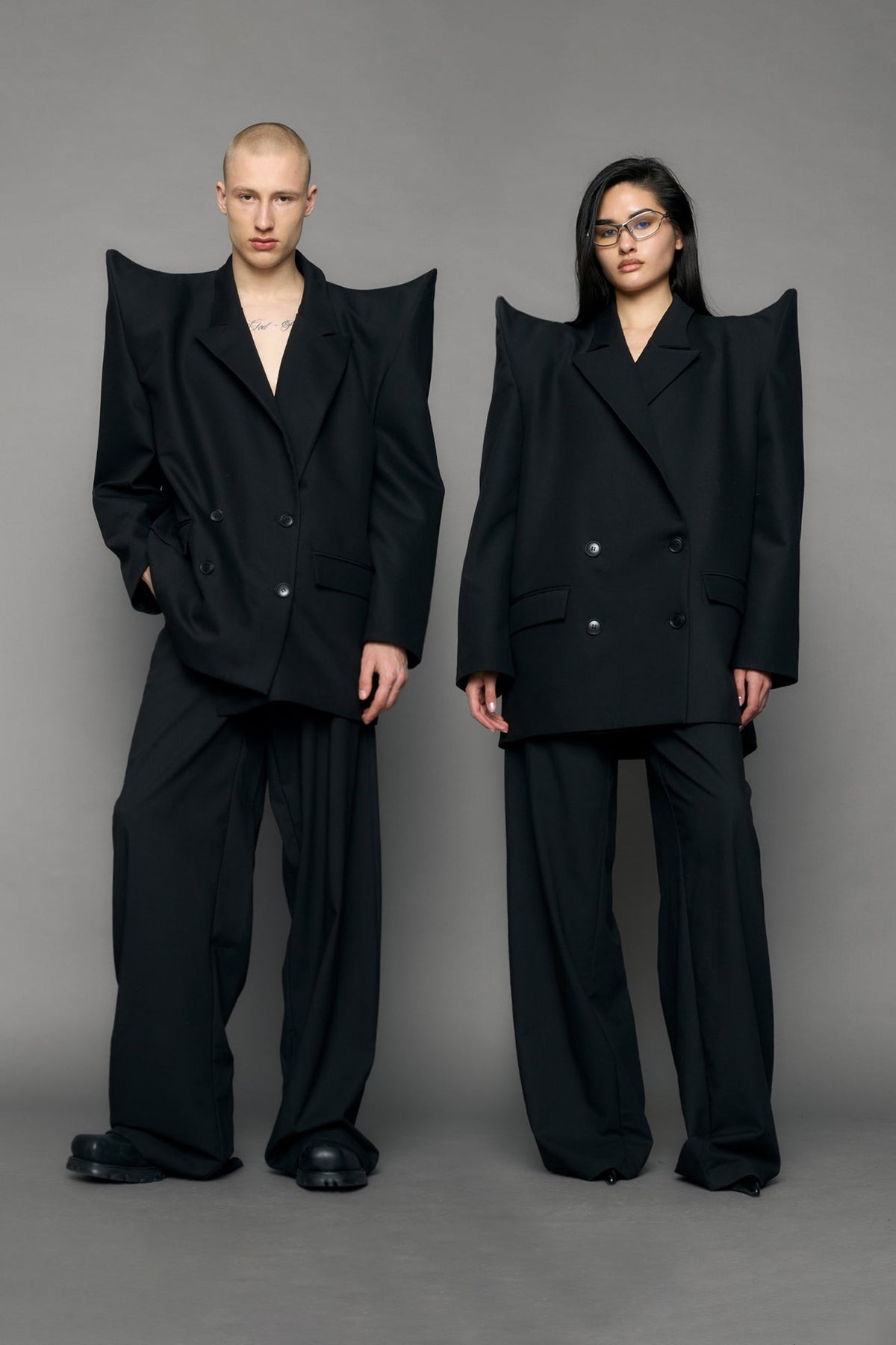 model wearing black blazer with sharp shoulder design