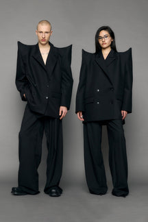 model wearing black blazer with sharp shoulder design