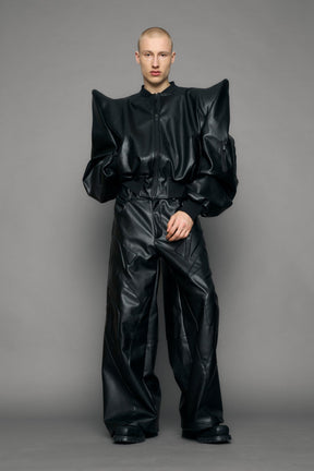 model wearing black pu leather bomber jacket with sharp shoulder design