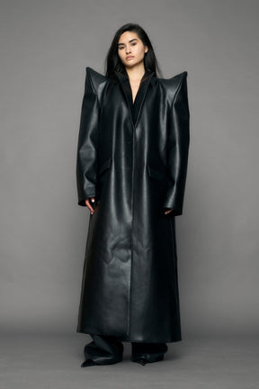 model wearing black pu leather coat with sharp shoulder design