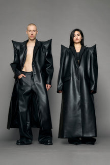 model wearing black pu leather coat with sharp shoulder design