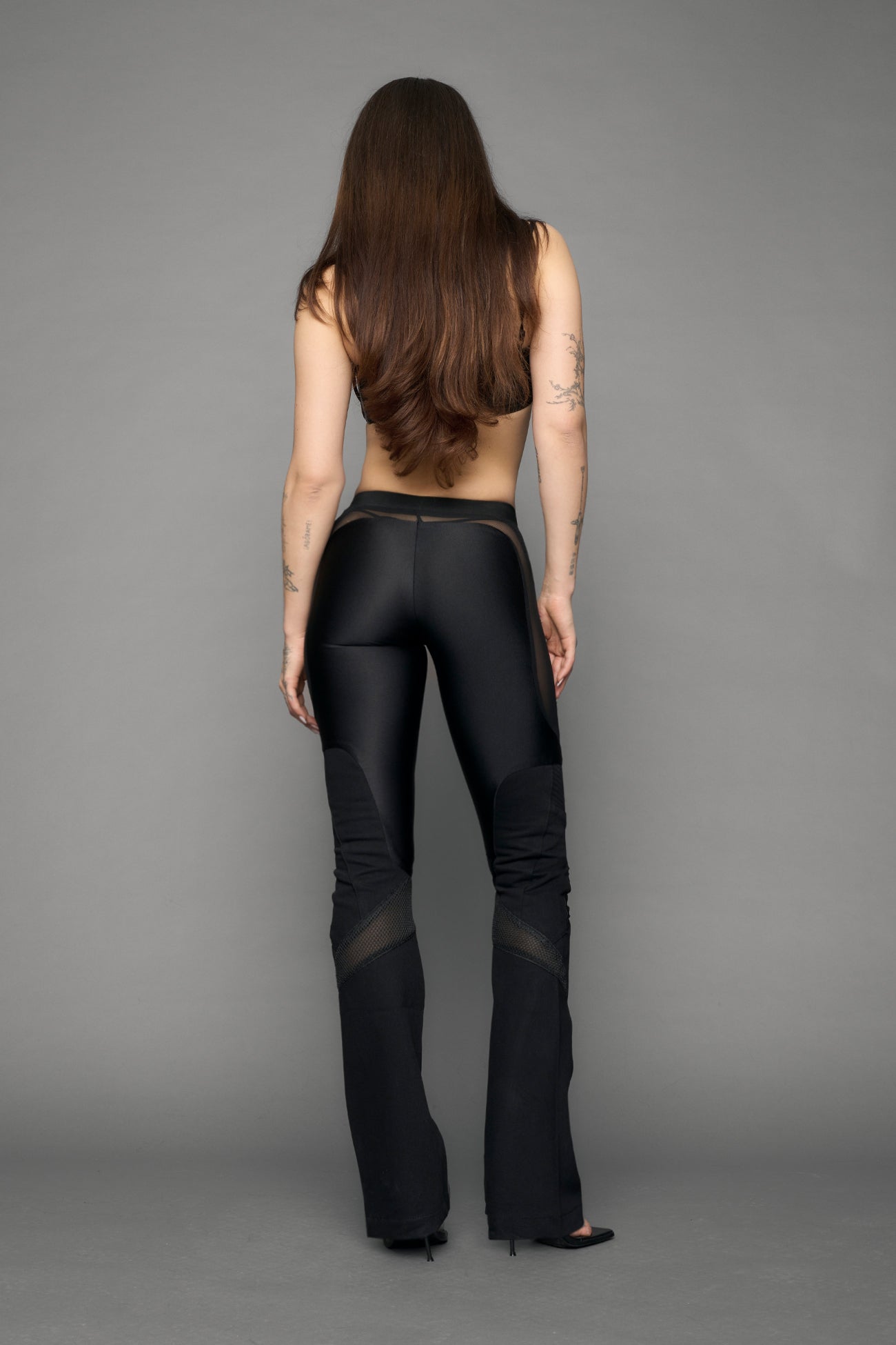 model wearing black denim moto mesh pants