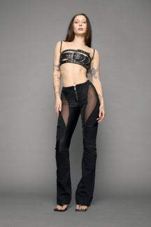 model wearing black denim moto mesh pants