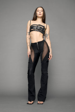 model wearing black denim moto mesh pants