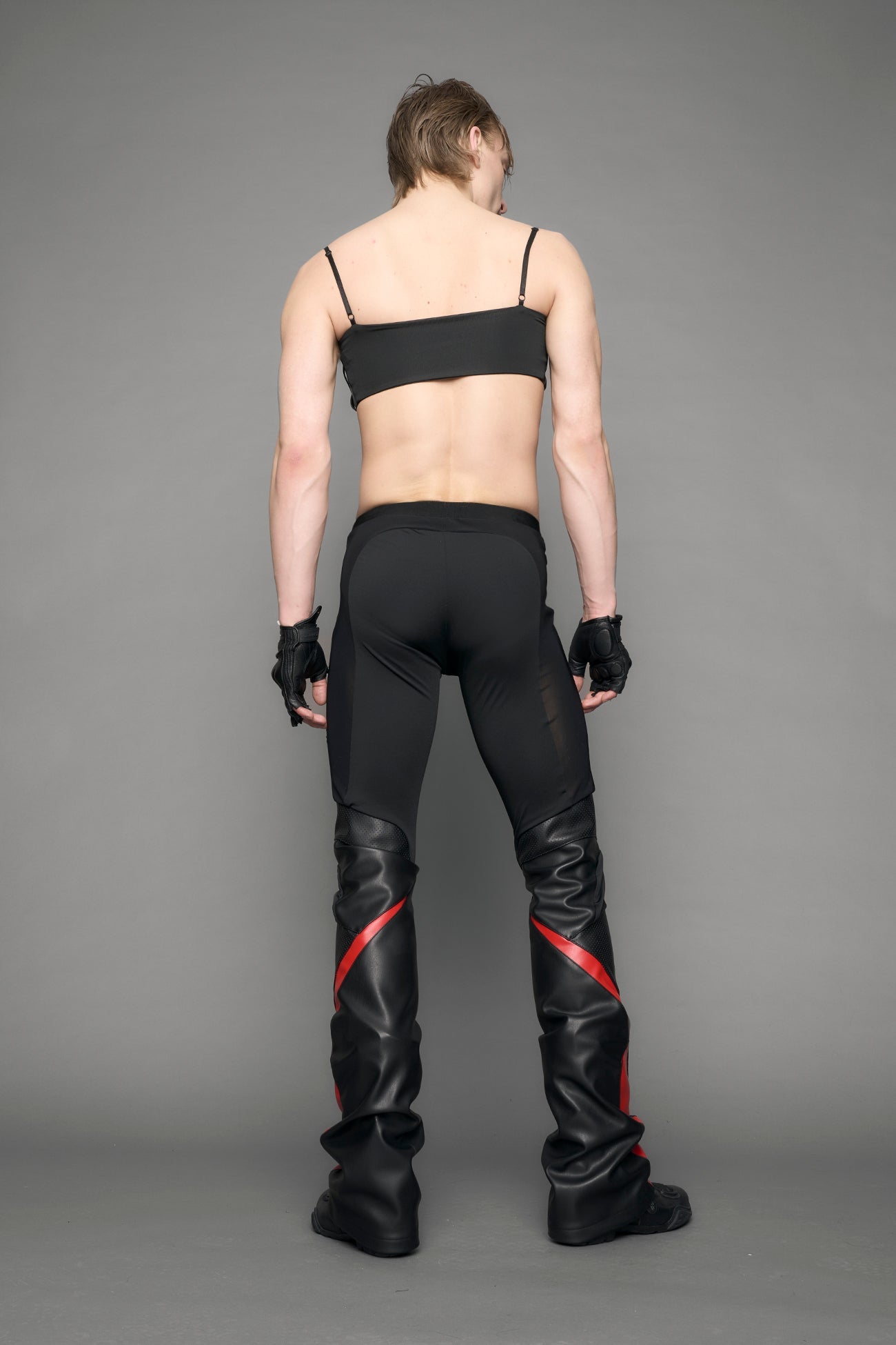 model wearing black red moto mesh pants