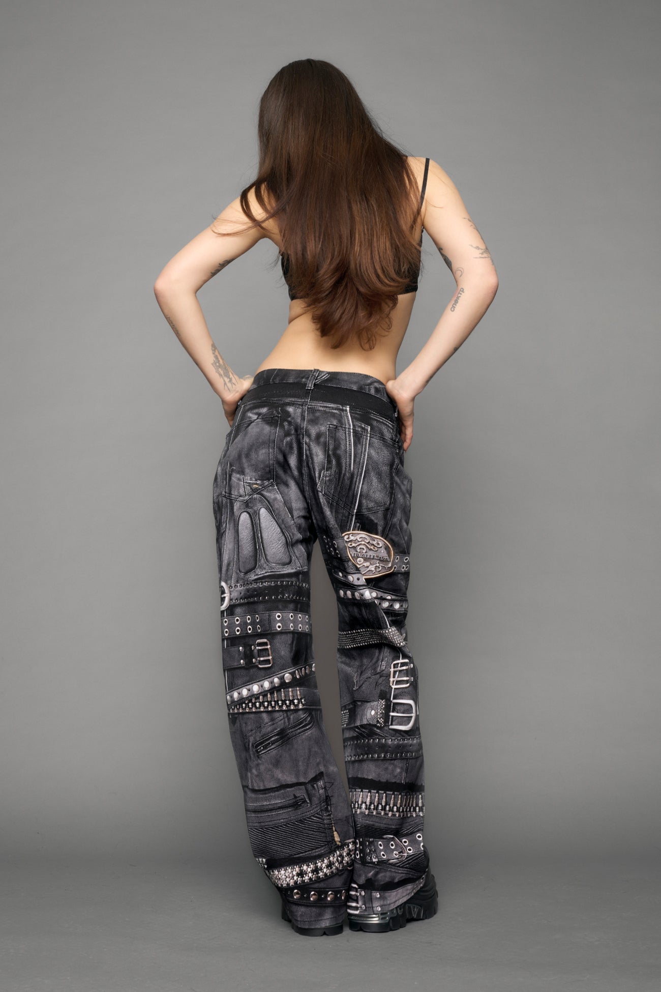 model wearing black printed motocross denim pants