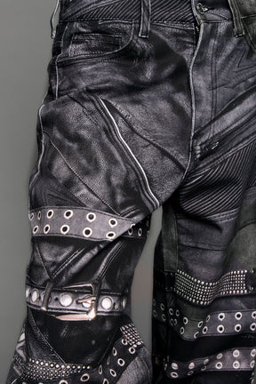 model wearing black printed motocross denim pants