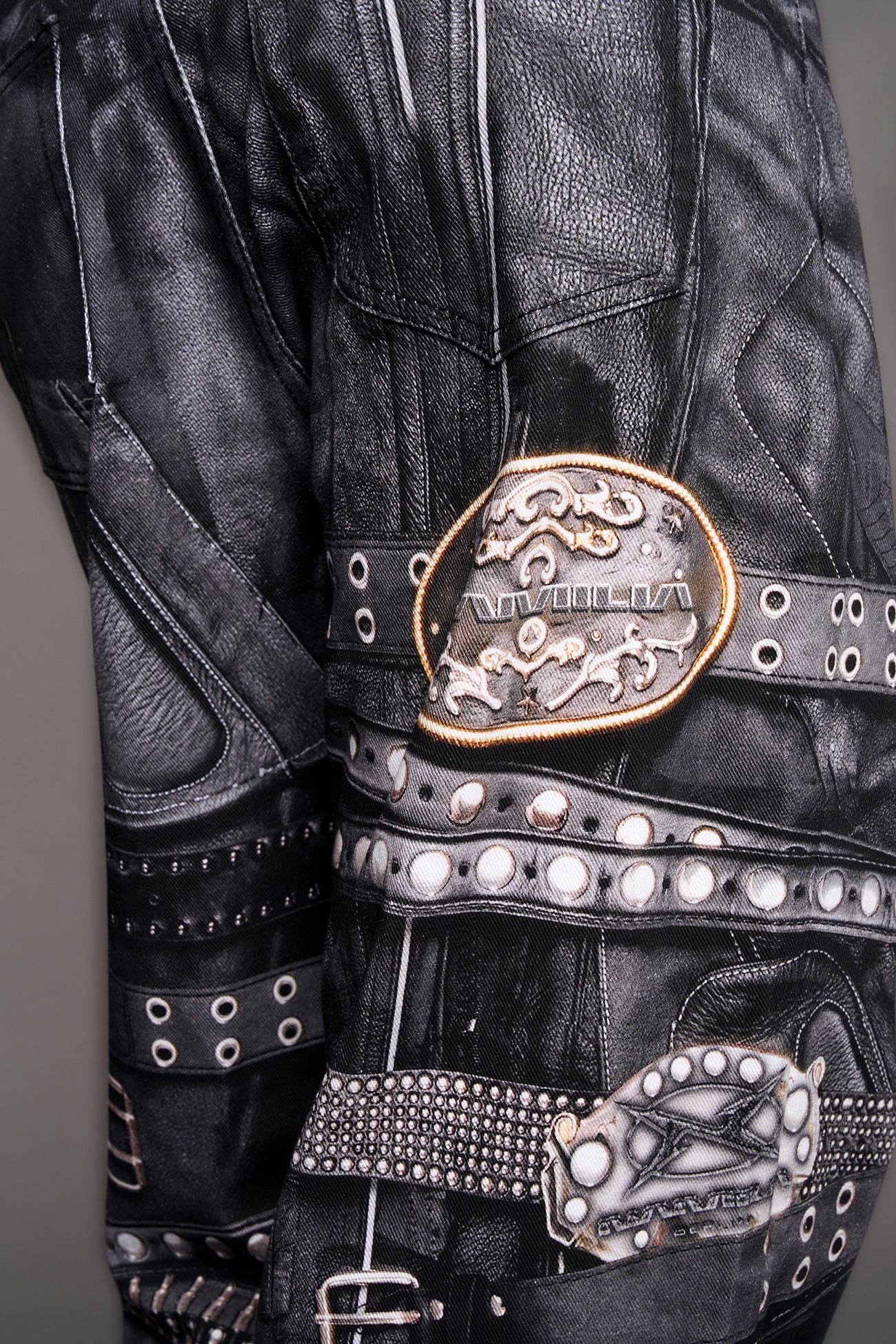 model wearing black printed motocross denim pants