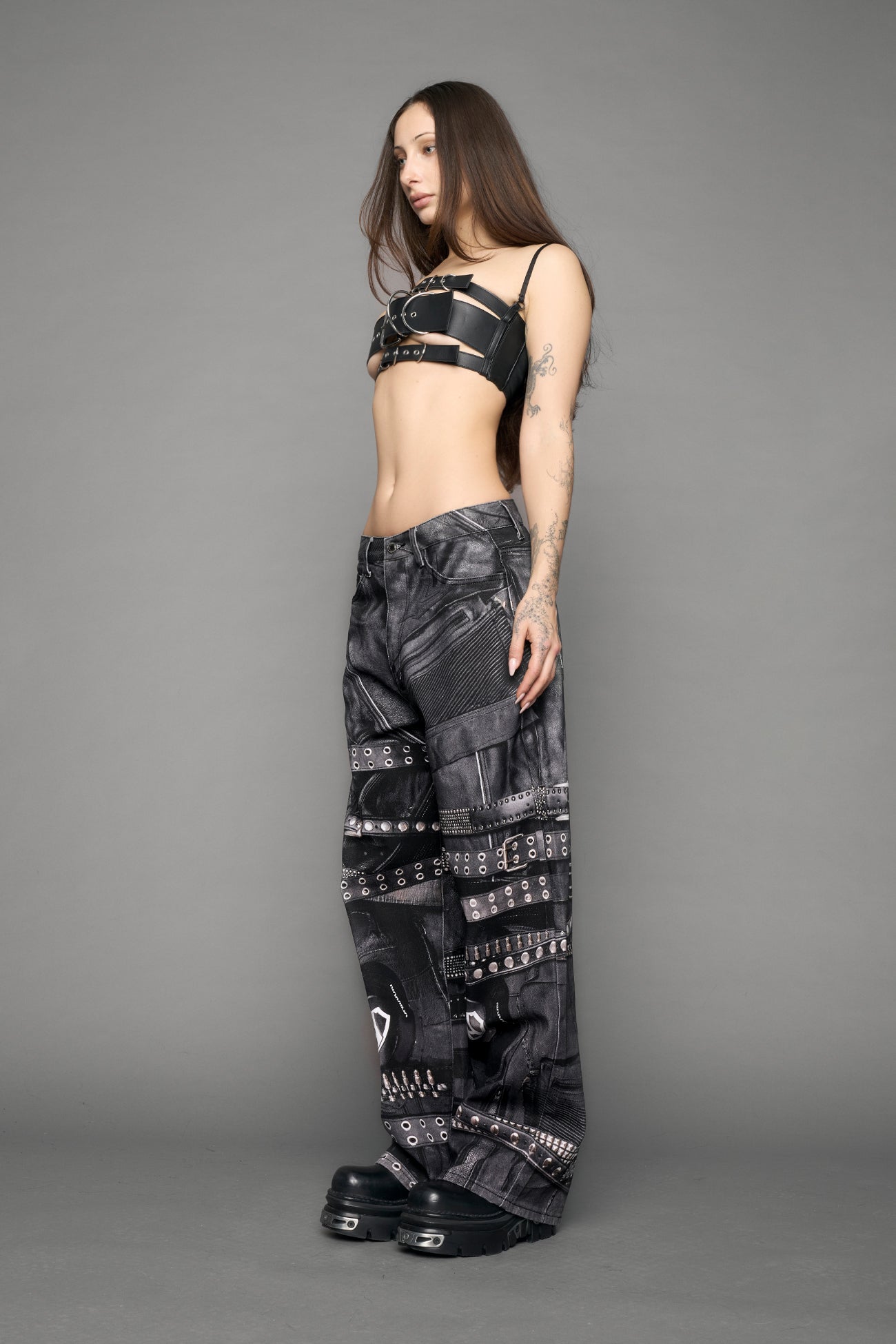 model wearing black printed motocross denim pants