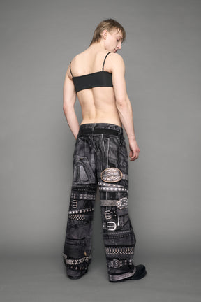 model wearing black printed motocross denim pants