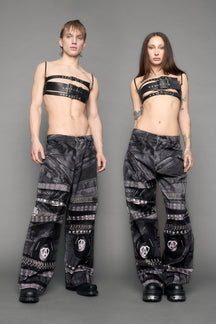 model wearing black printed motocross denim pants