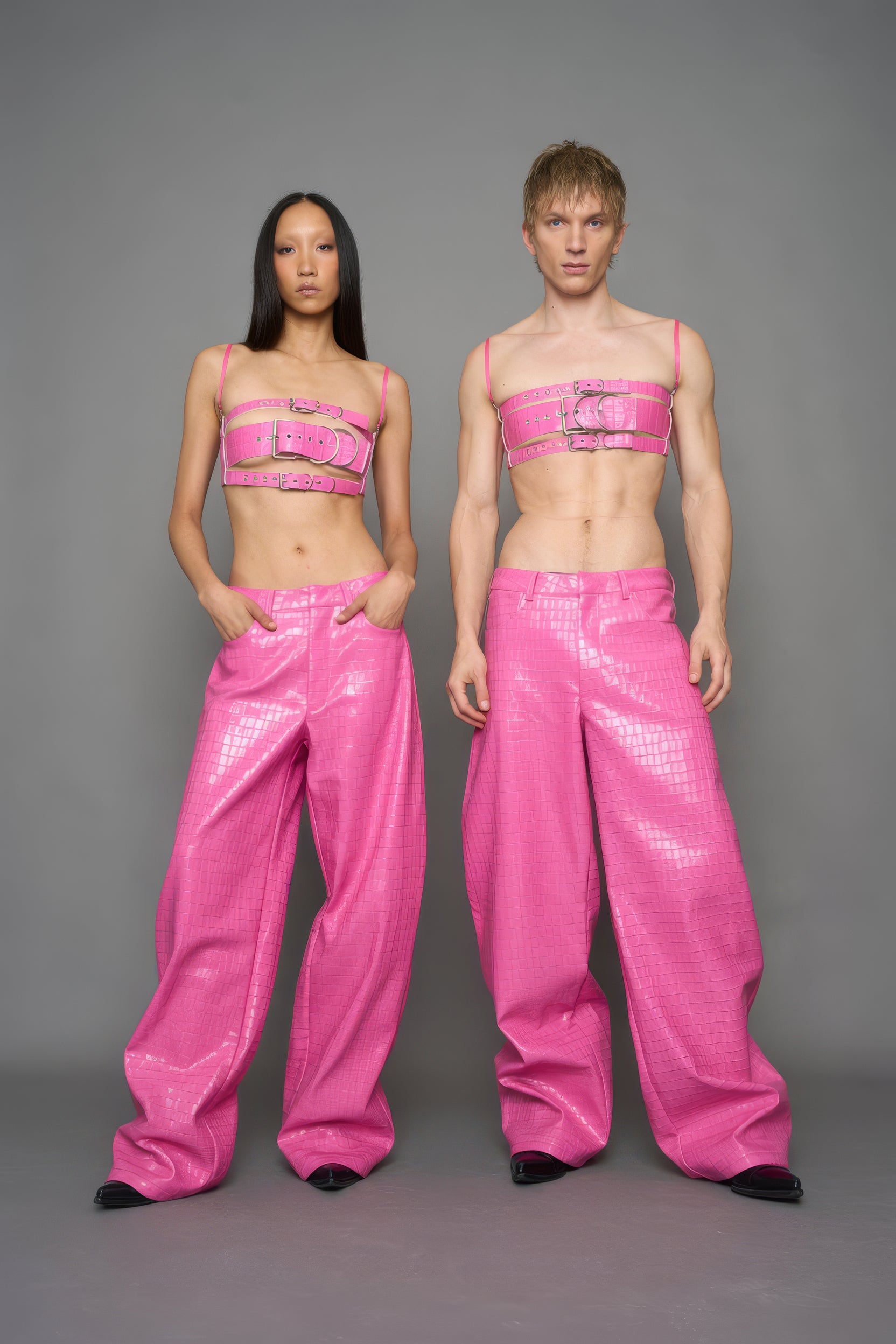 two models wearing pink vegan leather croc baggy pants