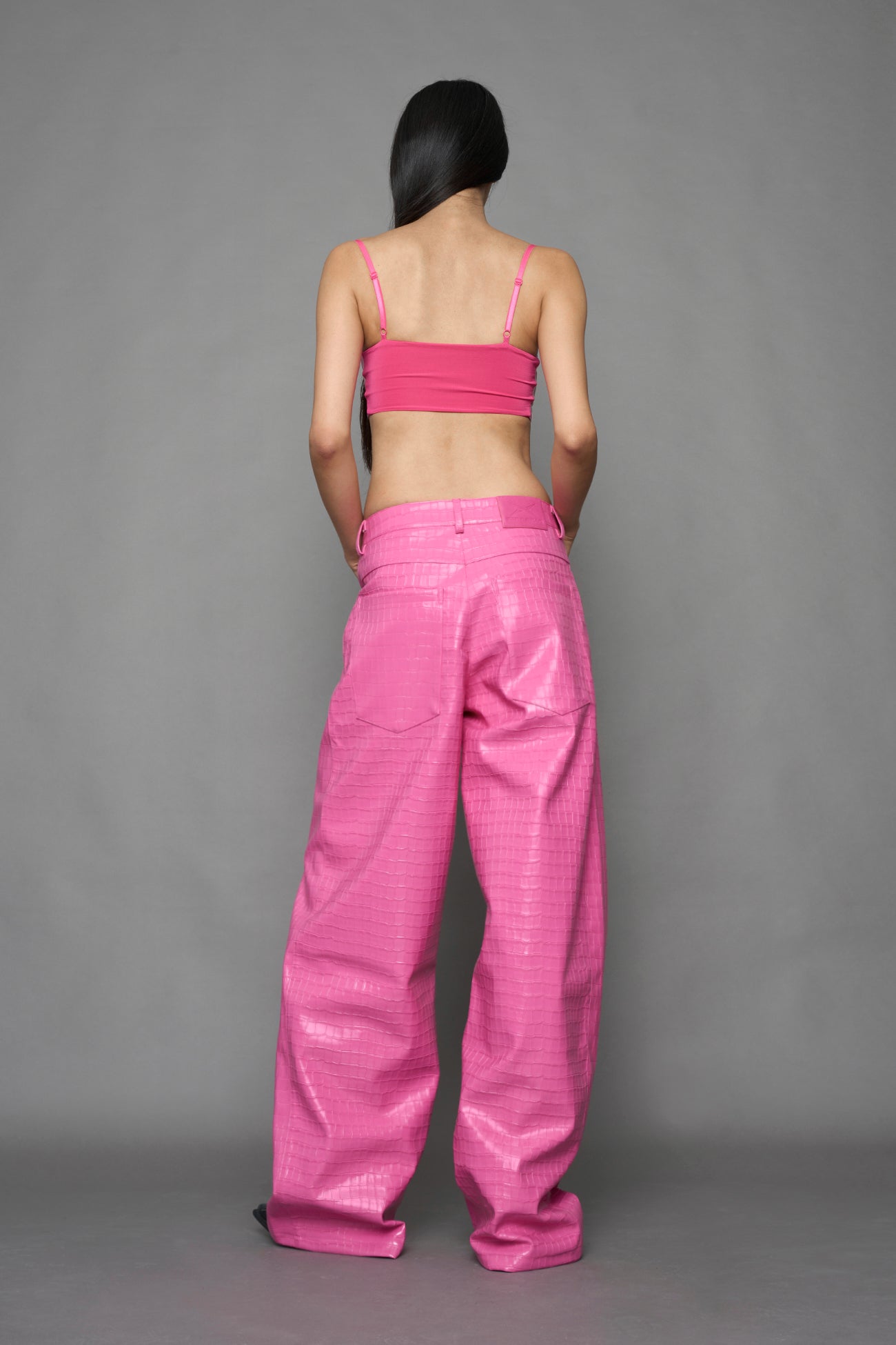 model wearing pink vegan leather croc baggy pants
