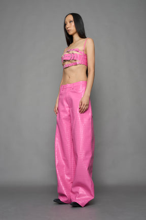 model wearing pink vegan leather croc baggy pants