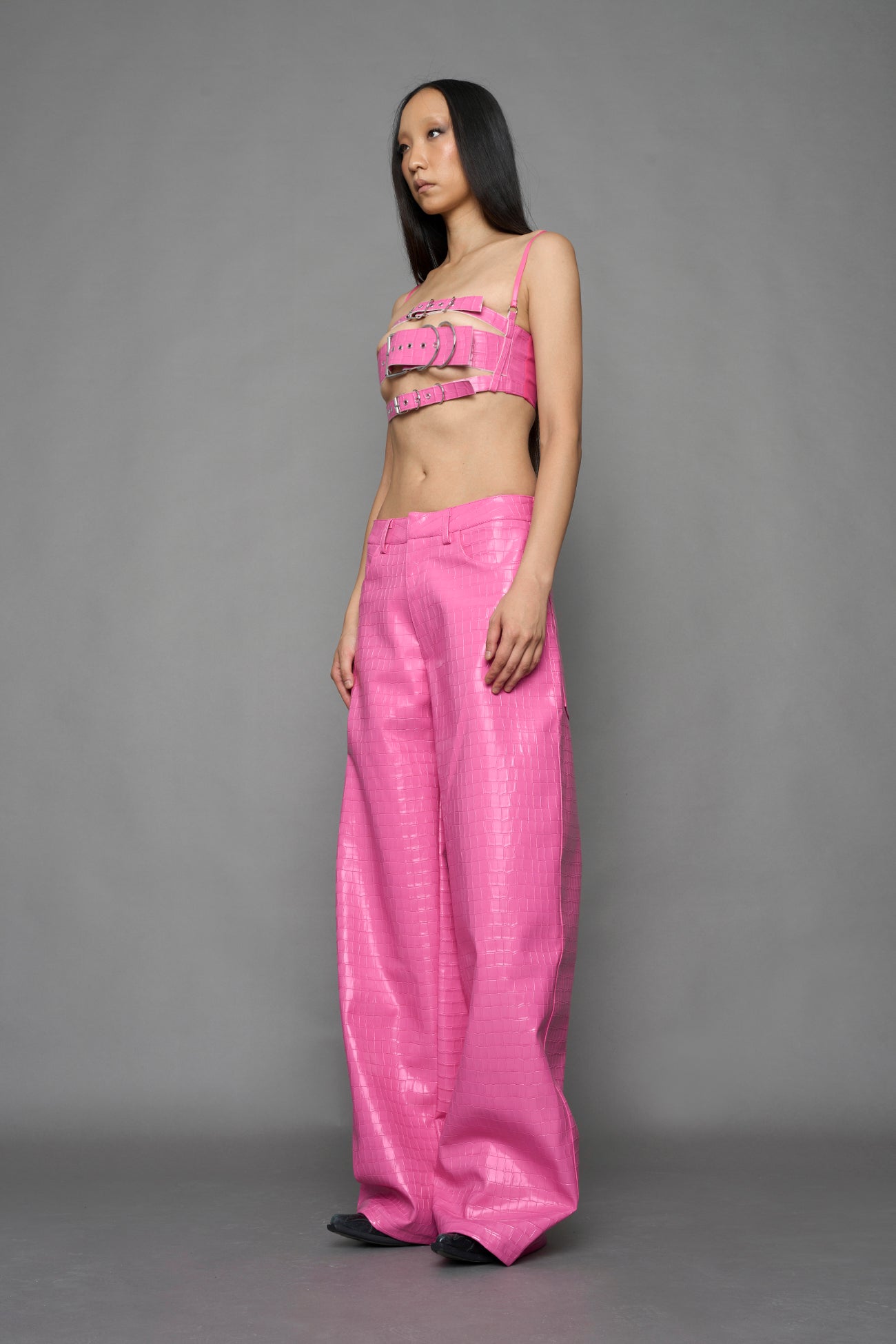 model wearing pink vegan leather croc belt top with buckle details