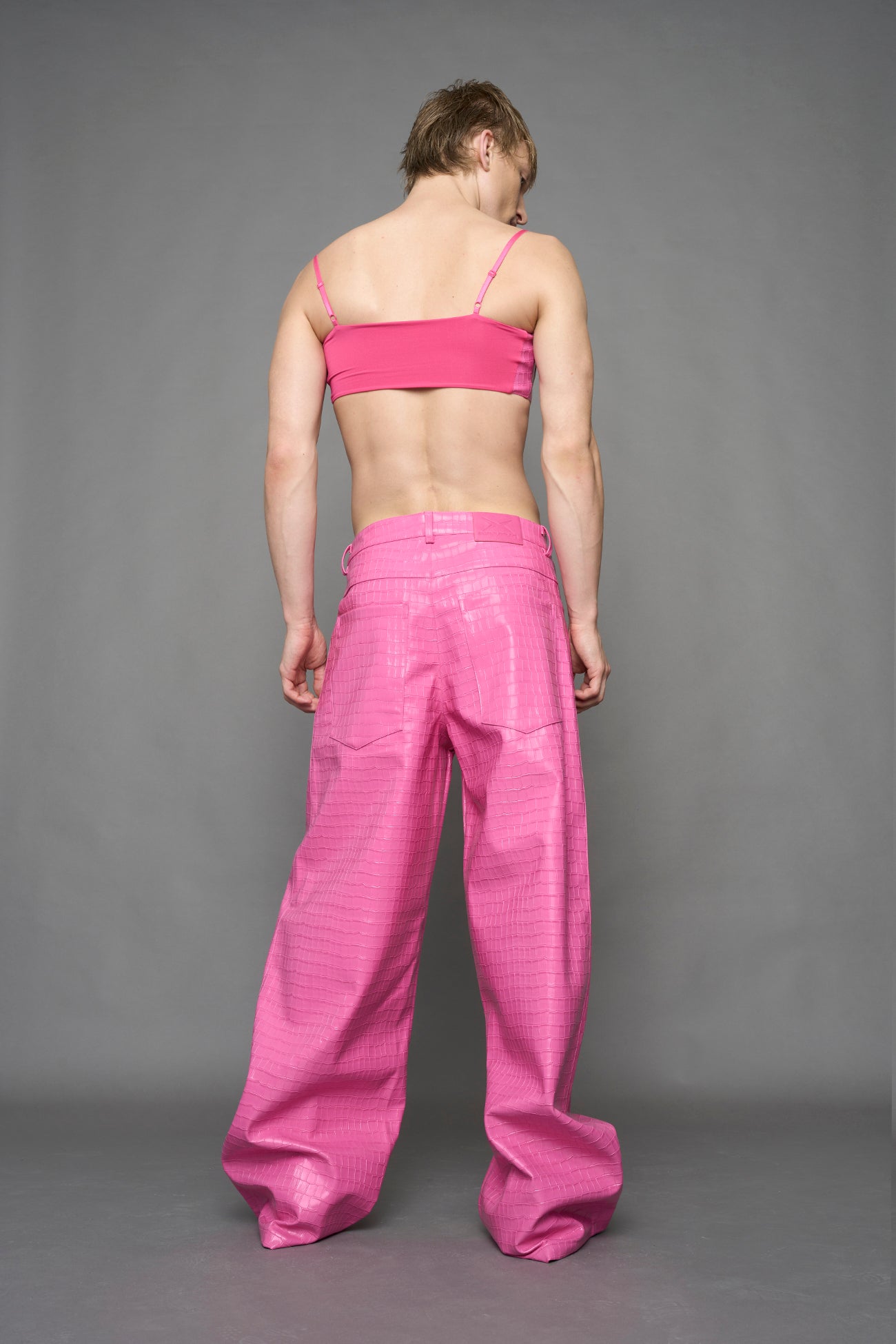 model wearing pink vegan leather croc baggy pants