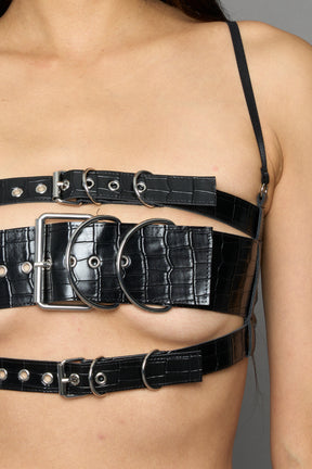model wearing black vegan leather croc inspired belt top with buckle details