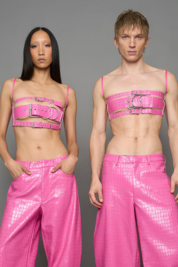 two models wearing pink vegan leather croc belt top with buckle details
